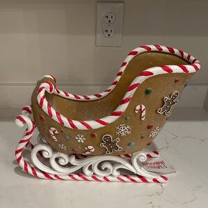 Festive Holiday Sleigh Decoration with Candy Cane Accents Gingerbread Men